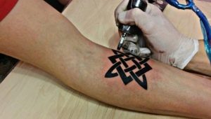 Tattoo amulets for men and their meaning