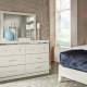 White chest of drawers in the interior of the bedroom
