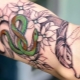 Review of men's tattoo with snakes on the arm